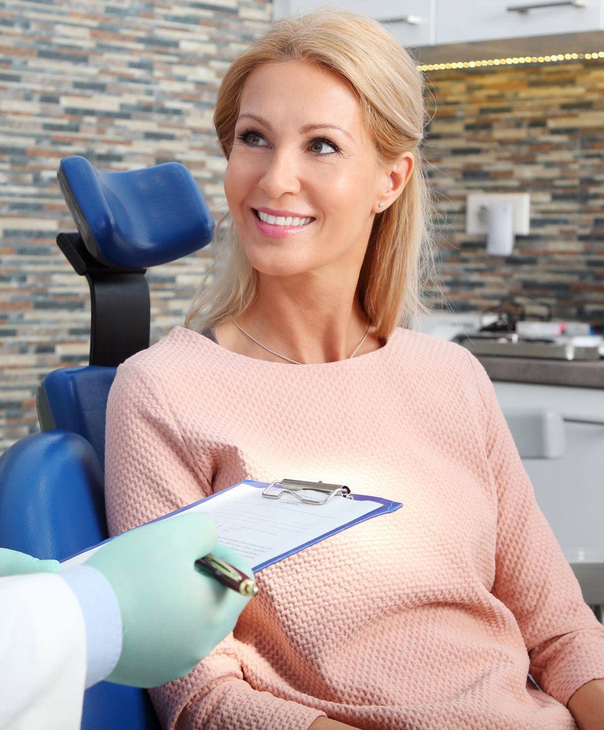 Patient smiling in dental office consultation.