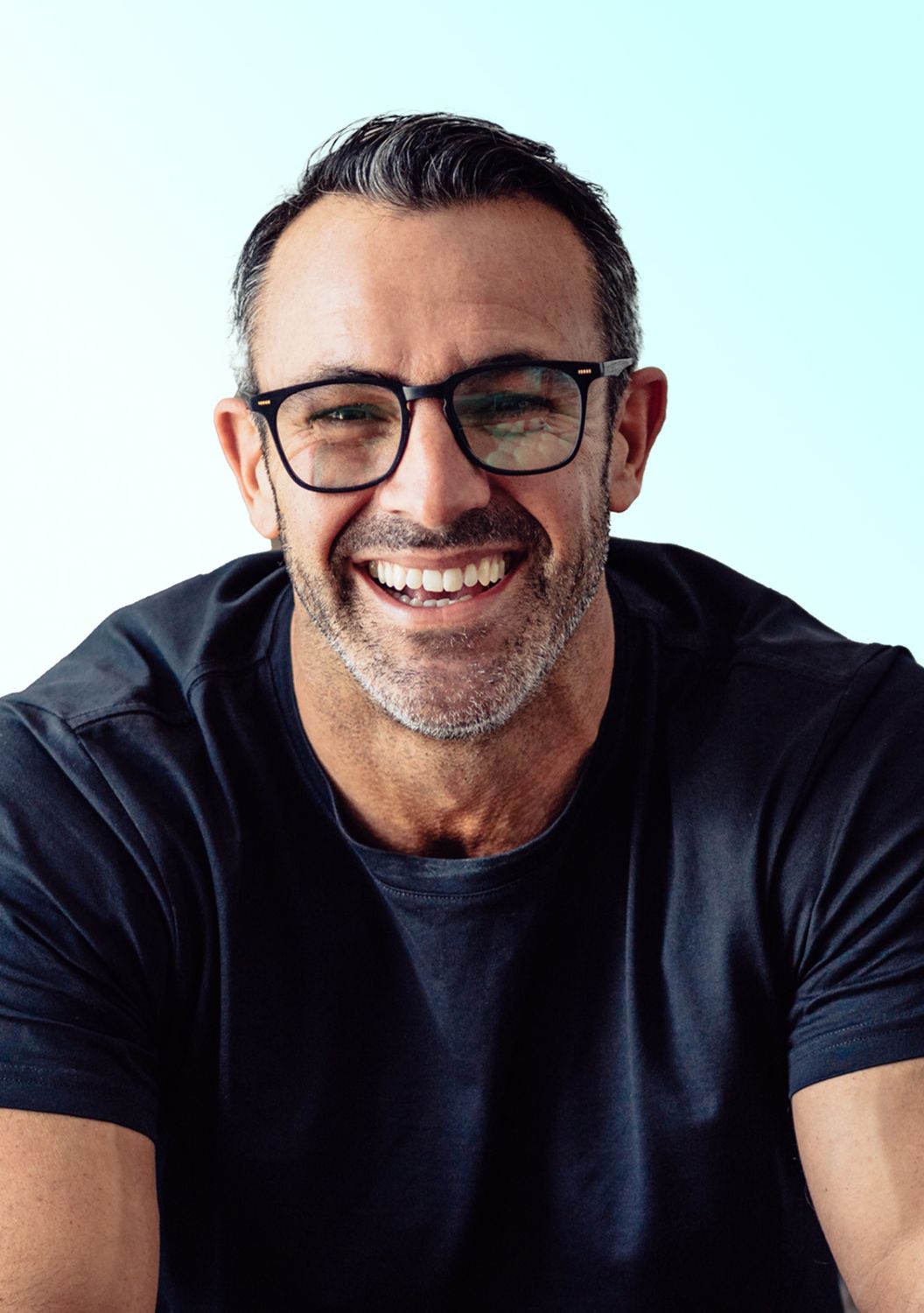 Smiling man in glasses with a friendly expression.