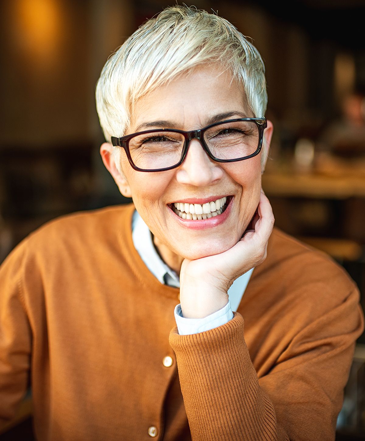 Smiling man wearing a backpack outdoors.