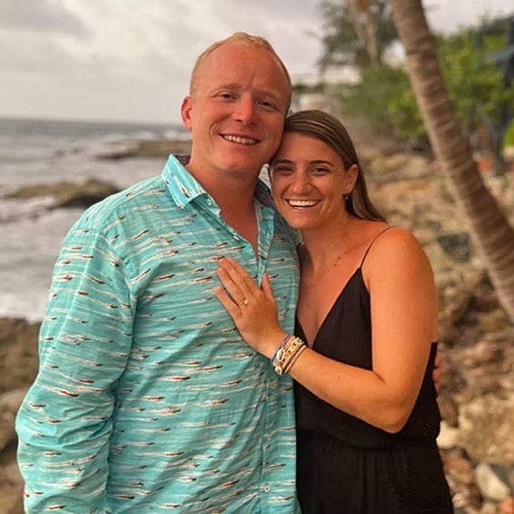 Couple posing happily by the seaside.