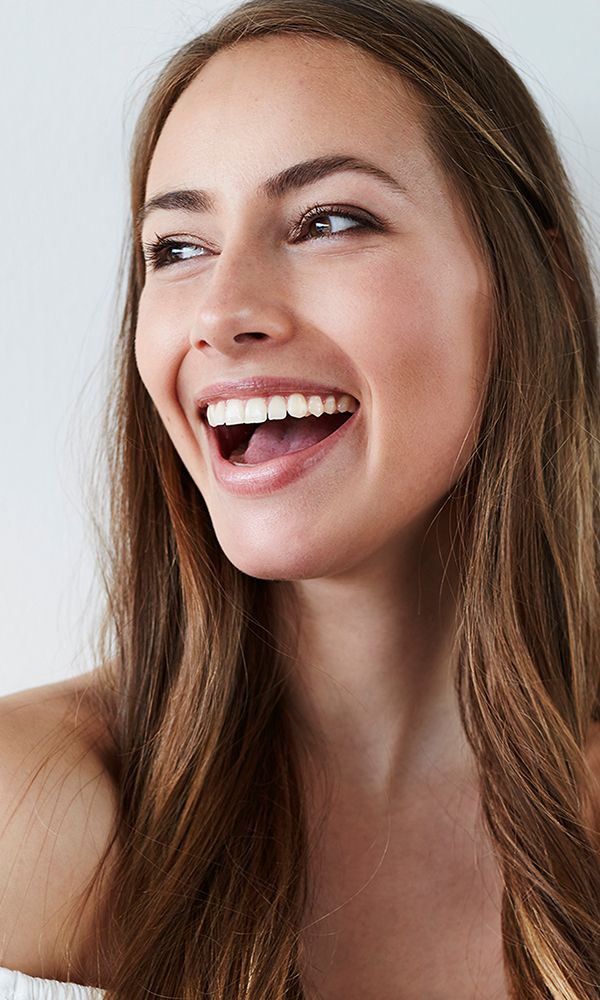 Smiling woman with long, flowing hair.