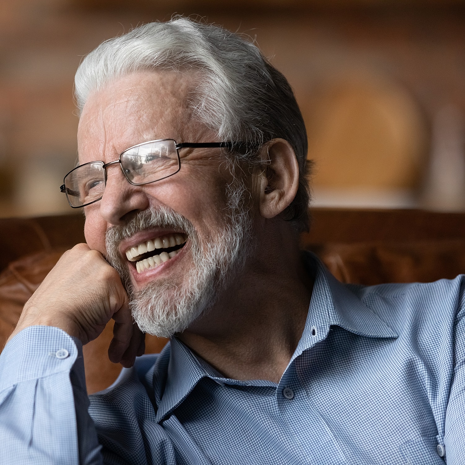 Smiling older man in glasses with full dental implant Brighton Dental Team