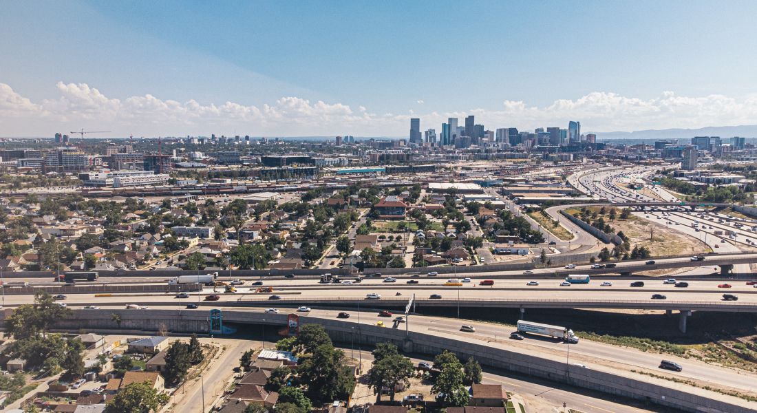 Aerial view of city with highways and buildings.