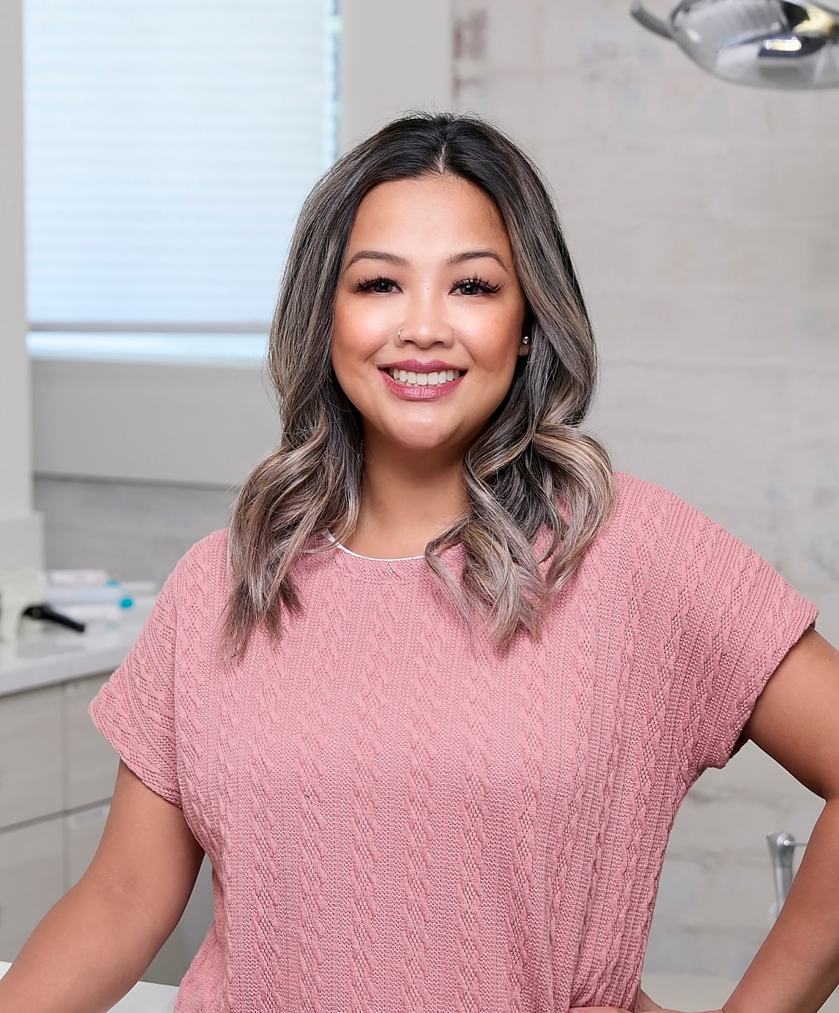 Family portrait by the water on a sunny day.