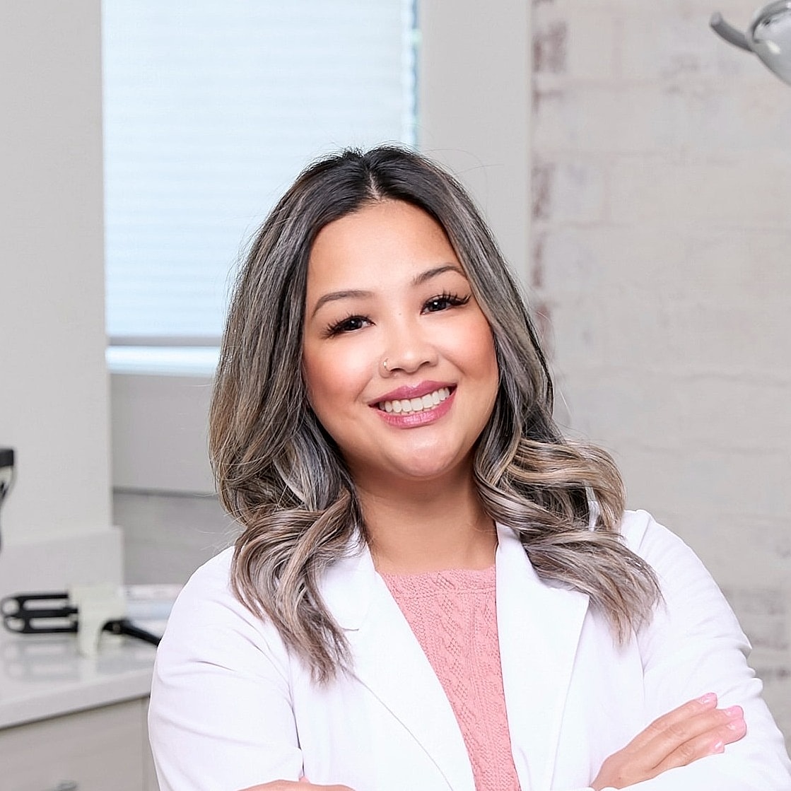 Smiling woman in a dental office setting.