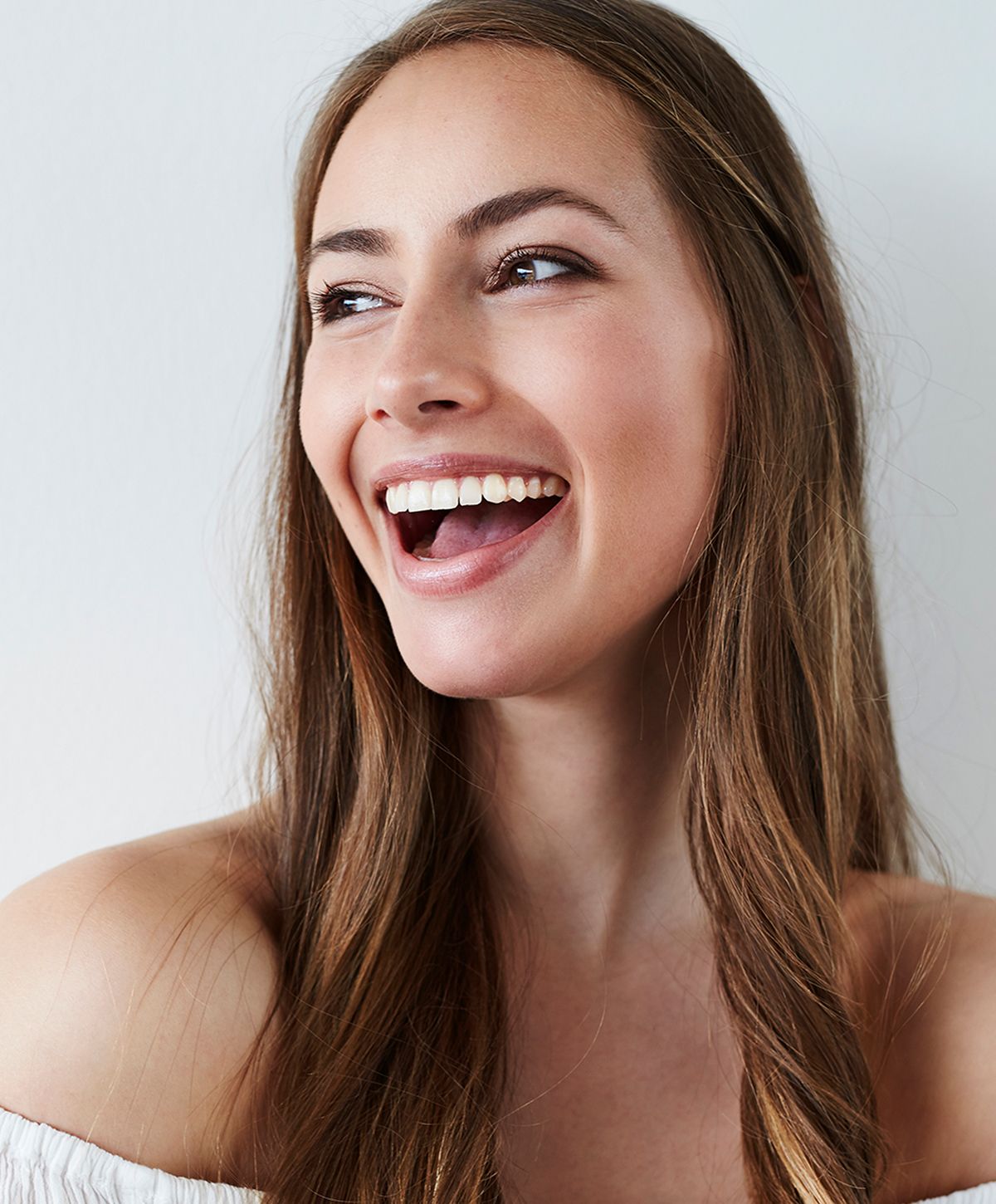 Smiling woman with long, flowing hair.