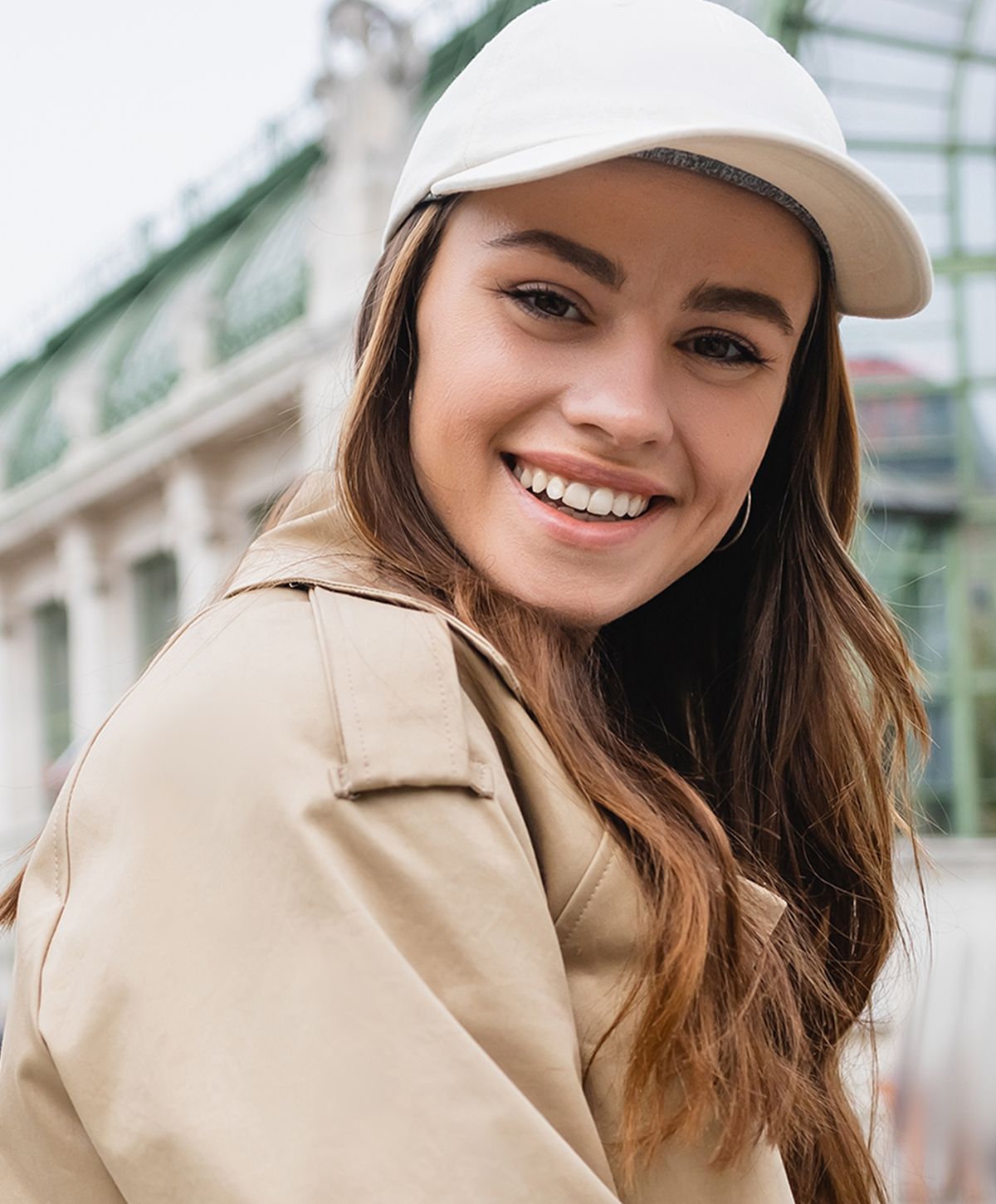 Smiling woman in a light-colored blouse.