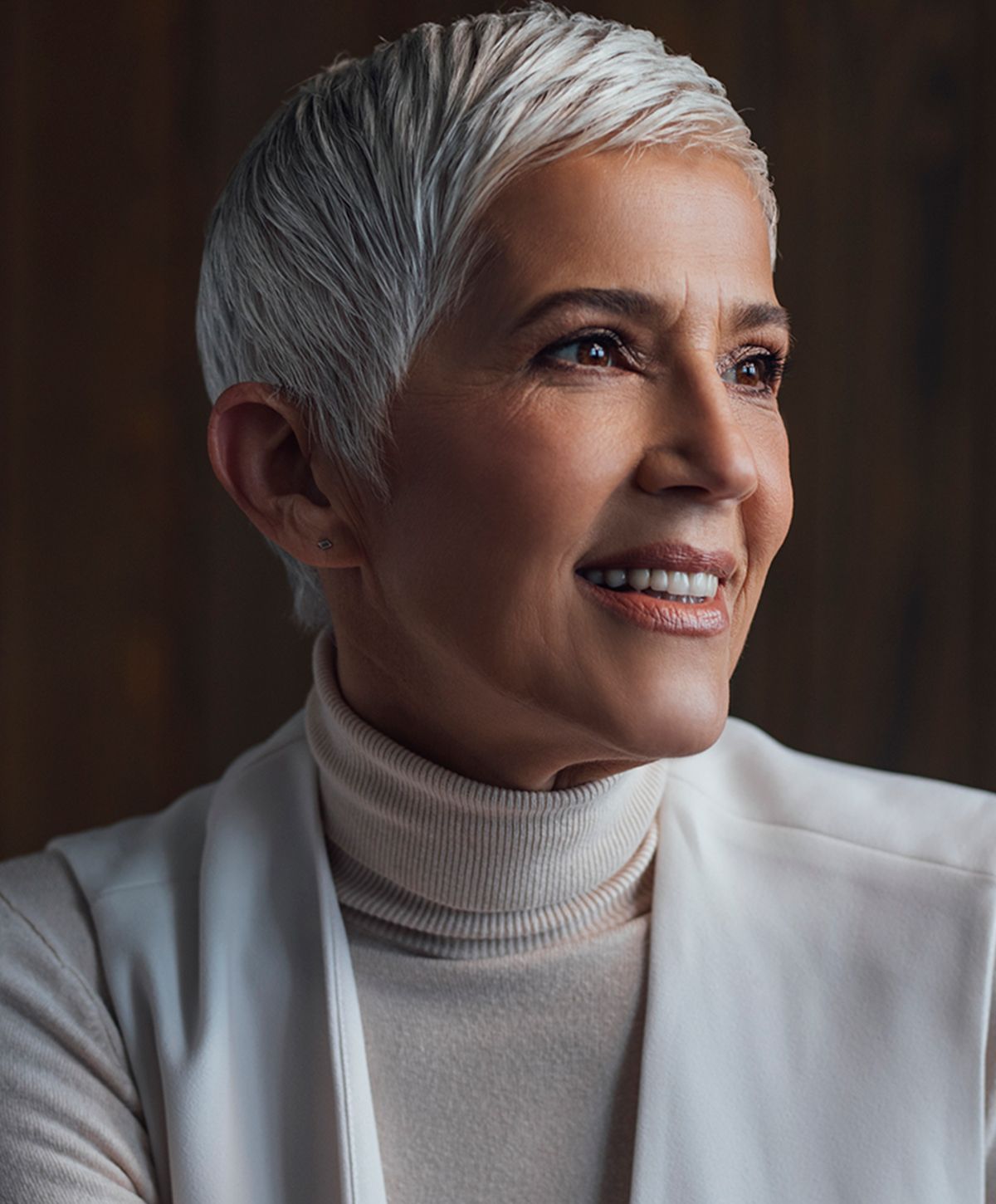 Smiling woman with short silver hair, portrait.