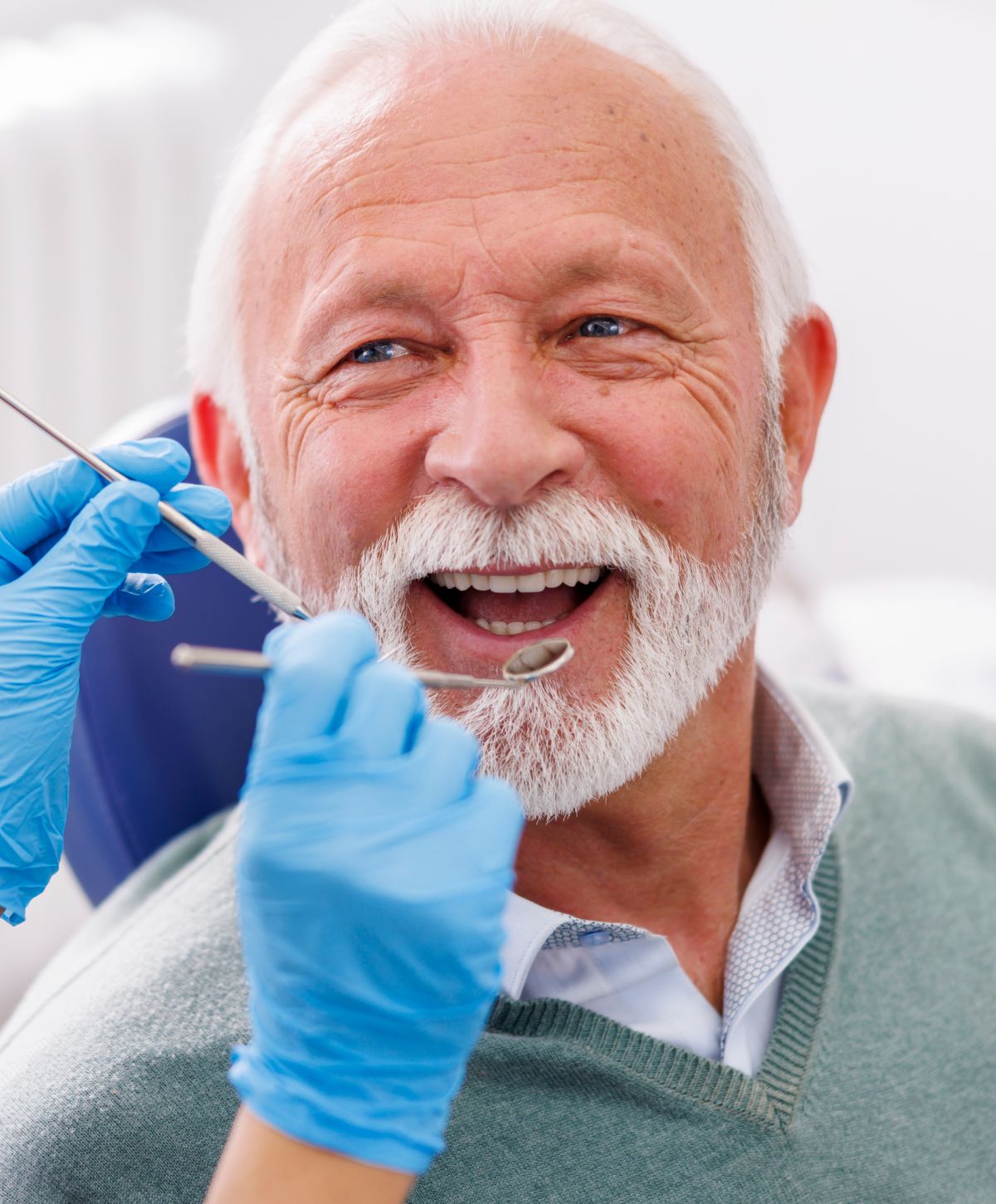 Senior man smiling during dental check-up.