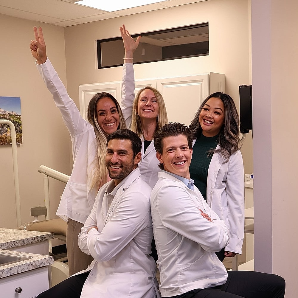 Smiling woman with long hair posing confidently.