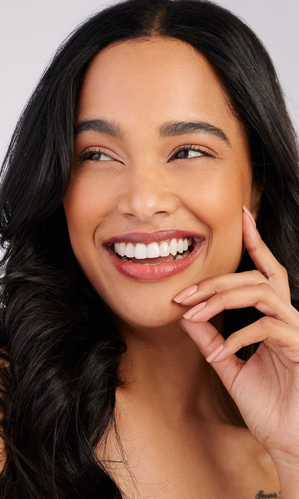 Smiling woman with long, flowing hair.
