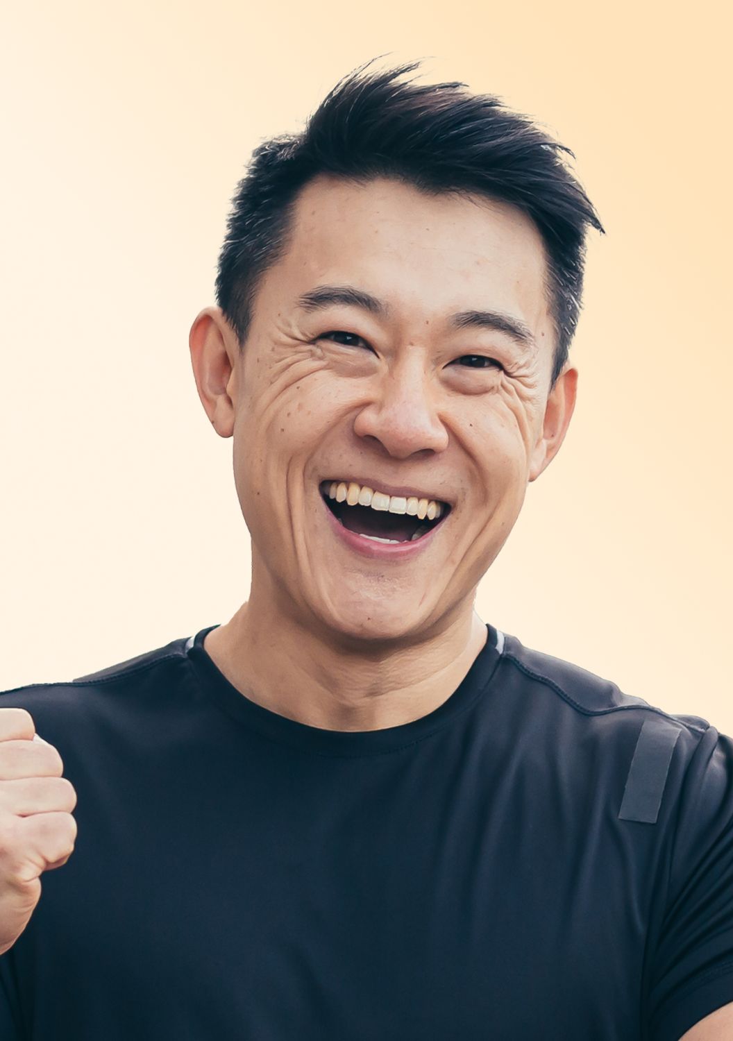 Man smiling joyfully with raised fist.