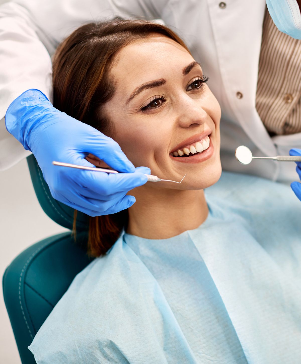 Patient smiling during dental check-up appointment.