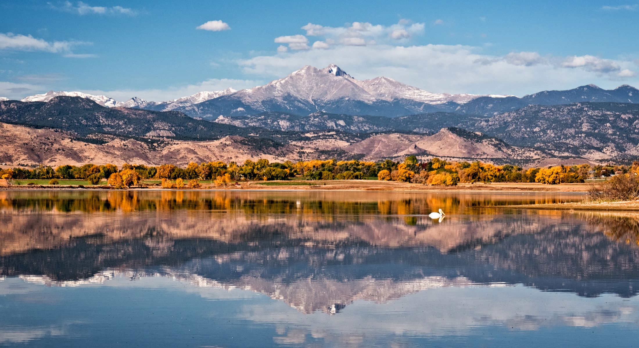 Serene mountain landscape reflecting in calm water.