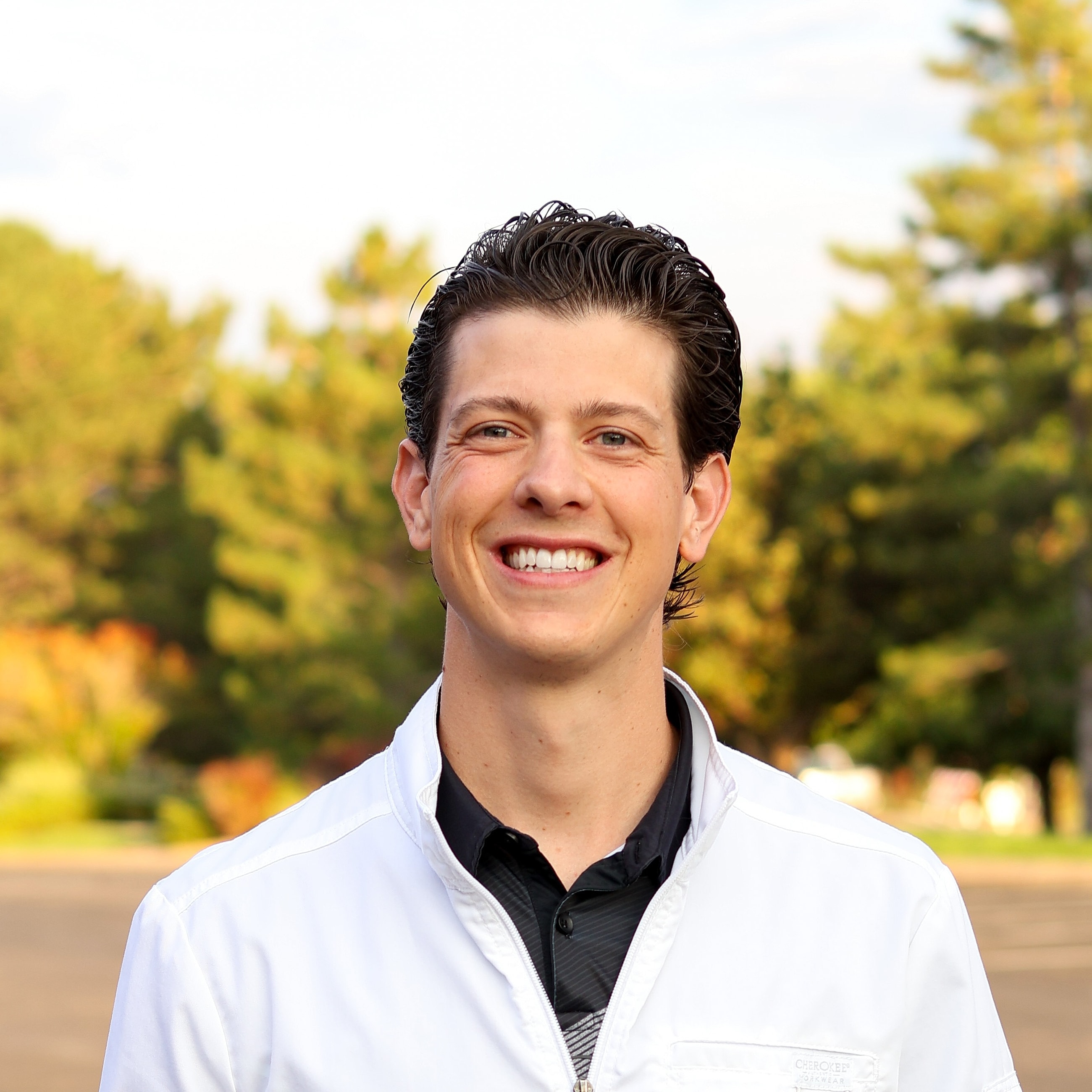 Family portrait with two children in outdoor setting.