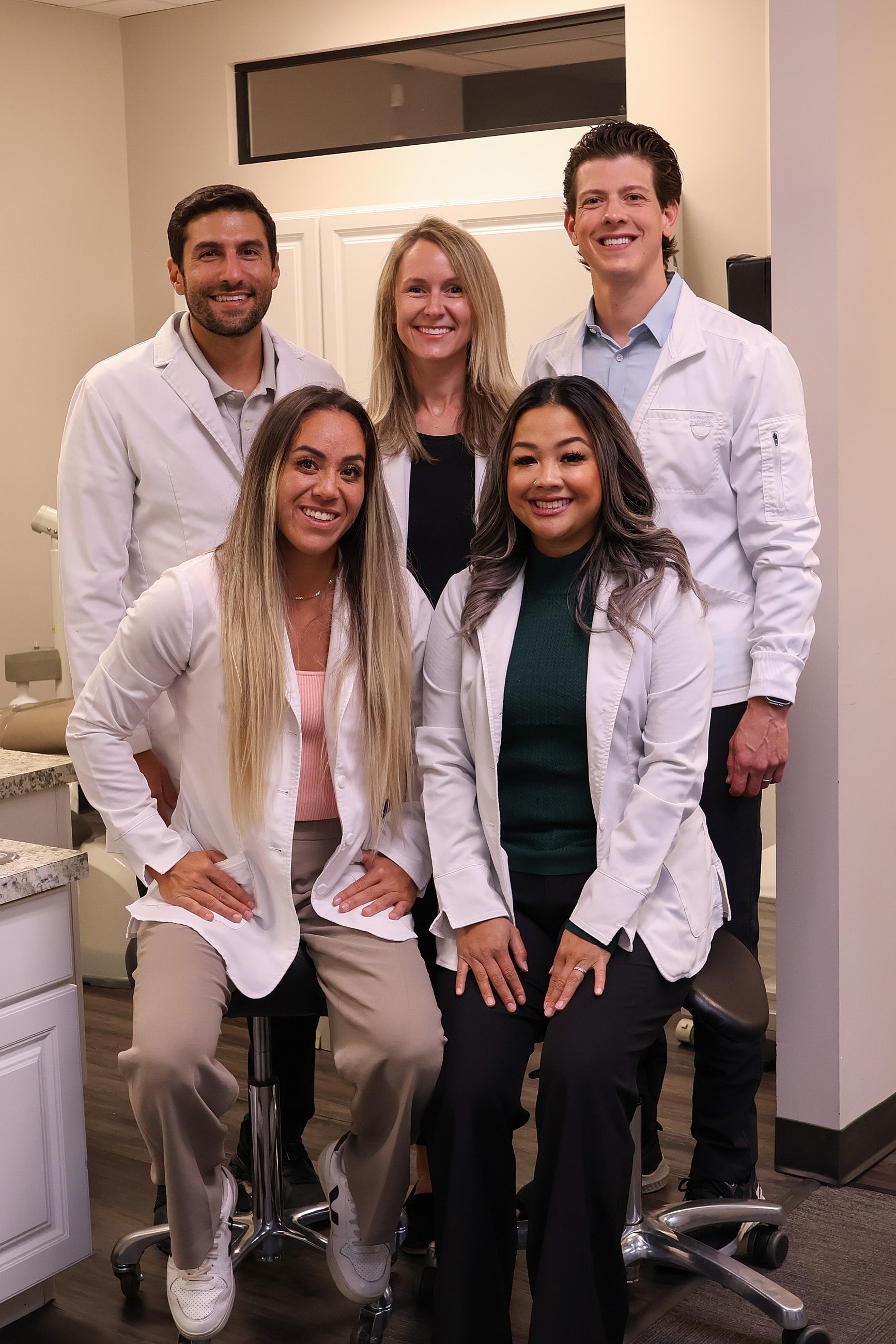 Two women smiling indoors together.