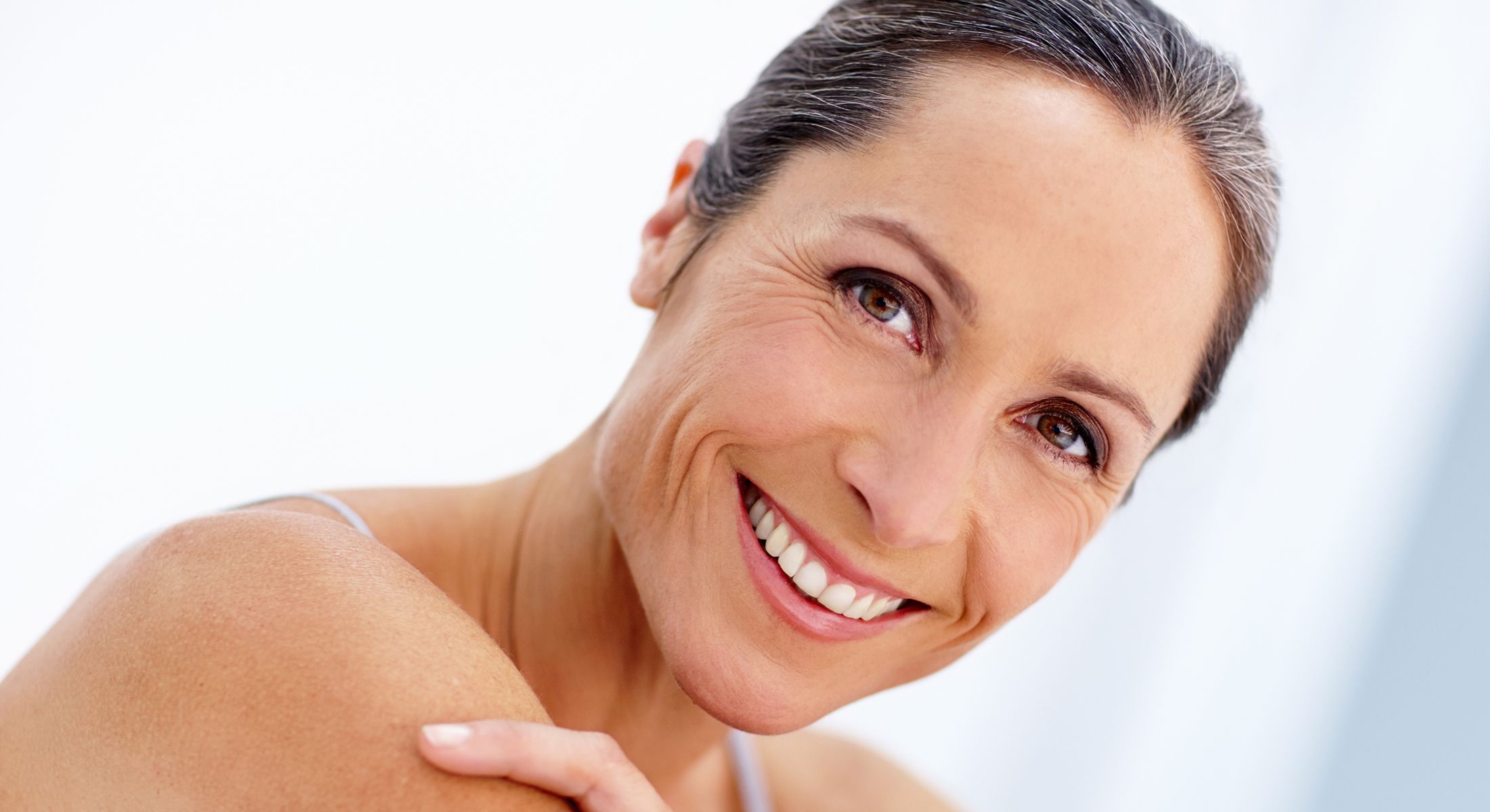 Smiling woman with healthy, radiant skin.