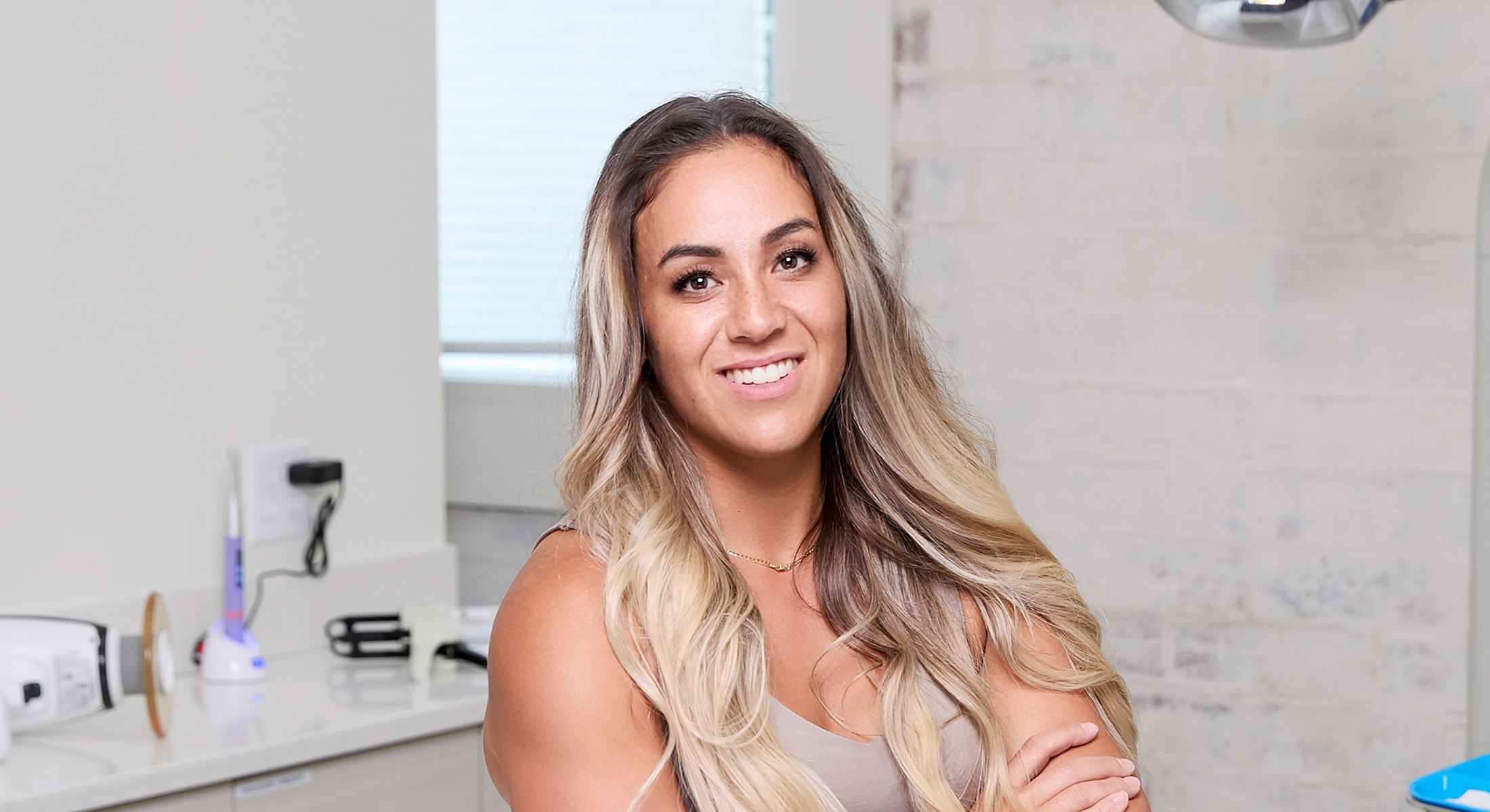 Smiling woman in a dental office setting.